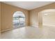 Inviting living room with neutral paint, tile flooring, large window with arch and great natural light at 15318 Harvest Blvd, Clermont, FL 34714