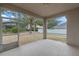 A view of the screened-in porch with a concrete floor and a view of the backyard at 15318 Harvest Blvd, Clermont, FL 34714