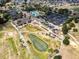 Aerial shot highlighting the clubhouse, putting green, and various community features at 15705 Sw 16Th Ter, Ocala, FL 34473