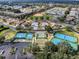 Aerial view of a community with tennis courts, shuffleboard courts, and a baseball field at 15705 Sw 16Th Ter, Ocala, FL 34473