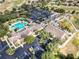 Aerial view showcases the clubhouse, pool, and parking areas within the community at 15705 Sw 16Th Ter, Ocala, FL 34473