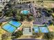 Aerial view of a community with a swimming pool, clubhouse, tennis, and shuffleboard courts at 15705 Sw 16Th Ter, Ocala, FL 34473