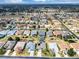 Expansive aerial view of a residential community showcasing uniform homes and well-maintained streets at 15705 Sw 16Th Ter, Ocala, FL 34473