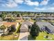 Aerial shot showcasing a neighborhood with well-maintained homes, lush landscaping, and a golf course in the background at 15705 Sw 16Th Ter, Ocala, FL 34473