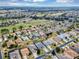 A sweeping aerial perspective of a community, highlighting its golf course and residential layout at 15705 Sw 16Th Ter, Ocala, FL 34473