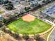 Aerial view of a well-maintained baseball field surrounded by a community and parking area at 15705 Sw 16Th Ter, Ocala, FL 34473