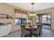 The bright dining area features a glass table, six chairs, and a sliding glass door to the lanai at 15705 Sw 16Th Ter, Ocala, FL 34473