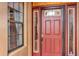 Close-up of the front door featuring sidelights and decorative glass, adding character and charm to the entrance at 15705 Sw 16Th Ter, Ocala, FL 34473