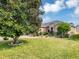 Well-maintained front yard of a home featuring lush green grass and a mature magnolia tree providing shade and character at 15705 Sw 16Th Ter, Ocala, FL 34473