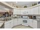 Well-equipped kitchen featuring white appliances, granite countertops, and ample counter space at 15705 Sw 16Th Ter, Ocala, FL 34473