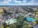 Aerial view of community amenities featuring a pool, community center, and blue tennis courts surrounded by lush landscaping at 15705 Sw 16Th Ter, Ocala, FL 34473