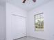 Bedroom featuring neutral walls, tile flooring, closet with doors, and a window at 15760 Sw 55Th Avenue Rd, Ocala, FL 34473