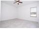 Bright bedroom features a ceiling fan, tiled floor, and window with blinds at 15760 Sw 55Th Avenue Rd, Ocala, FL 34473