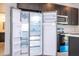 Spacious stainless steel refrigerator with ice maker inside a modern kitchen with black cabinets at 15760 Sw 55Th Avenue Rd, Ocala, FL 34473