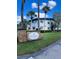 Beautiful Waterfall Cove condo complex with mature landscaping, blue skies, and palm trees at 1695 Lee Rd # B109, Winter Park, FL 32789