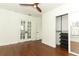 Bedroom featuring a double door entry, hardwood floors, and open closet with shelves at 2006 N Westmoreland Dr, Orlando, FL 32804