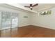 Bright bedroom featuring wood floors, sliding glass door and a ceiling fan at 2006 N Westmoreland Dr, Orlando, FL 32804