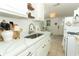 Well-lit kitchen features white cabinetry, stainless steel sink, marble countertops, and modern appliances at 2006 N Westmoreland Dr, Orlando, FL 32804