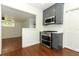 Charming kitchen featuring gray cabinets, stainless steel appliances, and hardwood floors at 2006 N Westmoreland Dr, Orlando, FL 32804