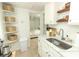 Bright kitchen with a stainless steel sink, corner shelving, and modern appliances at 2006 N Westmoreland Dr, Orlando, FL 32804