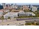 High-angle view of a modern apartment complex adjacent to a busy highway with city skyline at 206 E South St # 1030, Orlando, FL 32801