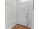 Clean and bright apartment entry door, with light wood floors and fresh white walls at 206 E South St # 1030, Orlando, FL 32801