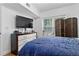 Spacious bedroom with large TV, natural light, and room for relaxation at 206 E South St # 1030, Orlando, FL 32801