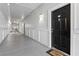 Long hallway with multiple apartment doors, painted in neutral colors with modern light fixtures and wood accents at 206 E South St # 1030, Orlando, FL 32801