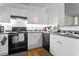 Well-lit kitchen features stainless steel appliances and sleek white cabinetry at 206 E South St # 1030, Orlando, FL 32801