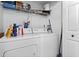 Practical laundry area with modern washer and dryer units and storage shelving at 206 E South St # 1030, Orlando, FL 32801