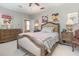 Bedroom featuring a ceiling fan, dresser, and art on the walls at 206 Norfolk Pl, Kissimmee, FL 34747