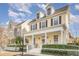 Inviting yellow home featuring a covered porch, white picket fence, and well-manicured landscaping at 206 Norfolk Pl, Kissimmee, FL 34747