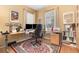 Home office with wood floors, natural light, a large desk, and built-in bookshelves at 206 Norfolk Pl, Kissimmee, FL 34747