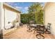 Inviting brick patio with outdoor seating and a grill, surrounded by lush landscaping at 206 Norfolk Pl, Kissimmee, FL 34747