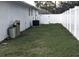 Spacious, fenced backyard with lawn and various home utilities at 207 Valencia Rd, Debary, FL 32713