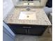 Vanity features a modern sink, granite countertop, and dark cabinets at 207 Valencia Rd, Debary, FL 32713