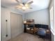 This bedroom is staged as an office with a ceiling fan and an area rug at 207 Valencia Rd, Debary, FL 32713