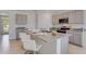 Bright kitchen featuring gray cabinets, a large granite island with seating, and modern appliances at 2116 Red Rock Rd, New Smyrna Beach, FL 32168