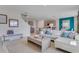 Open concept living room with a modern white sofa and a view to the kitchen at 2116 Red Rock Rd, New Smyrna Beach, FL 32168