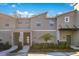 Modern townhome exterior featuring a contemporary design, manicured landscaping, and inviting entrances at 2377 Reading Trl, Kissimmee, FL 34746