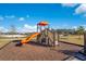 Community playground with orange slide and climbing structure for ' enjoyment at 2377 Reading Trl, Kissimmee, FL 34746