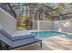 Sparkling pool with screened enclosure and lounge chairs for outdoor relaxation at 2377 Reading Trl, Kissimmee, FL 34746