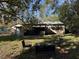 Backyard view of the home featuring a sitting area, green awnings, siding, and a screened-in porch at 2429 S Elm Ave, Sanford, FL 32771