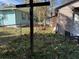 View of the backyard showcasing a wooden cross, shed, and fenced area, offering a serene outdoor setting at 2429 S Elm Ave, Sanford, FL 32771