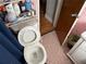 Modest bathroom features pink tiling, a black mat, and a white toilet at 2429 S Elm Ave, Sanford, FL 32771