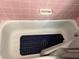 Vintage bathtub featuring a navy blue non-slip mat and pink tiling at 2429 S Elm Ave, Sanford, FL 32771