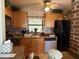 Cozy kitchen featuring wood cabinets, window over sink, and tile backsplash at 2429 S Elm Ave, Sanford, FL 32771