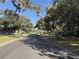 Neighborhood street view with mature trees providing shade to the road and sidewalk at 2429 S Elm Ave, Sanford, FL 32771