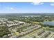 Aerial view of a beautiful residential community featuring well-manicured lawns and several ponds at 3422 Seneca Club Loop # 57, Orlando, FL 32808