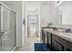 Bathroom featuring a double sink vanity, tile flooring, walk-in shower, and natural light at 3422 Seneca Club Loop # 57, Orlando, FL 32808